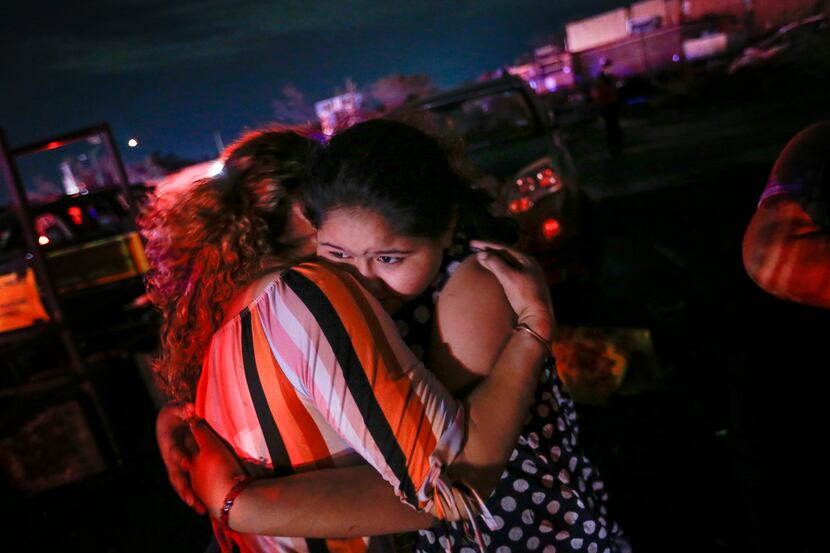 Allisson Landeros, 11, hugs her aunt Maria Lara in the parking lot of a shopping center near...