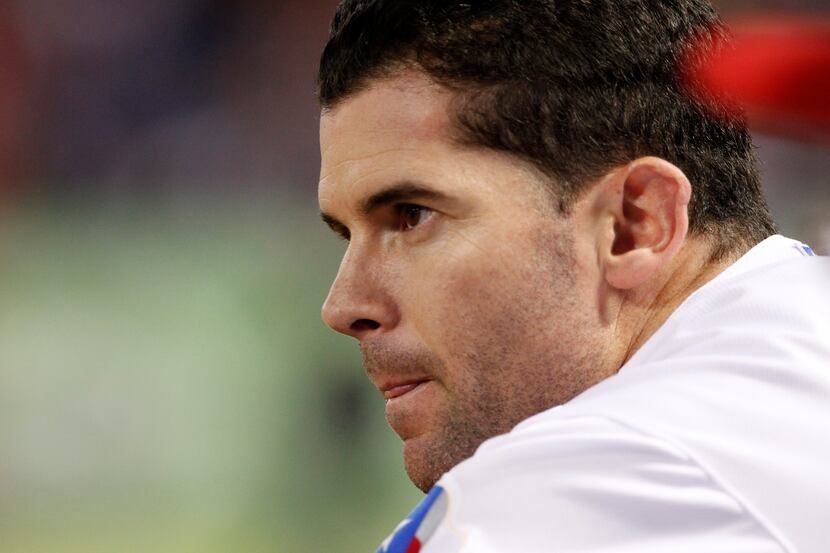 Texas Rangers' Michael Young watches from the dugout during an American League wild-card...