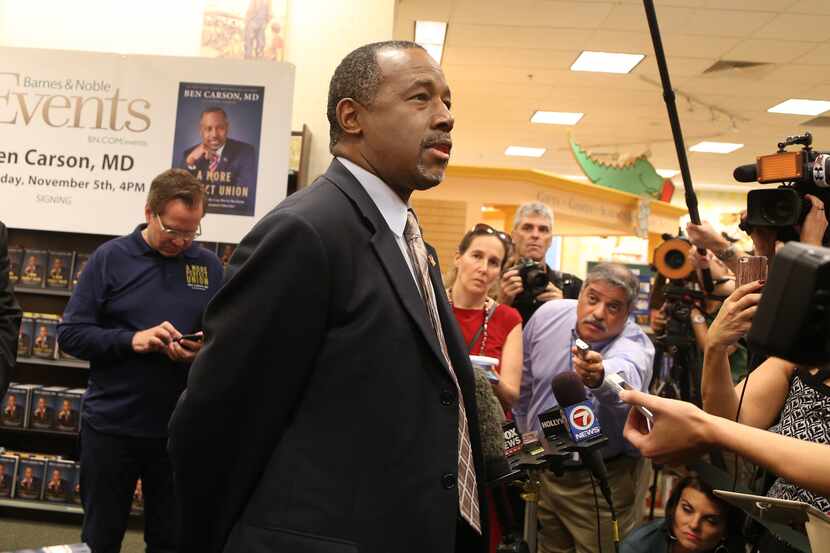 Republican presidential candidate Ben Carson talks to the media during a book signing at the...