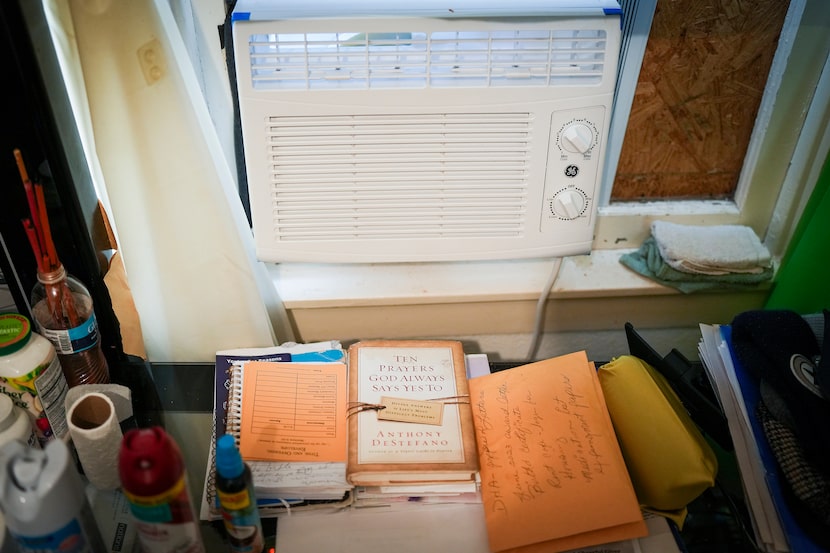 The book ‘Ten Prayers God Always Says Yes To’ sits beneath a new air conditioner in the room...