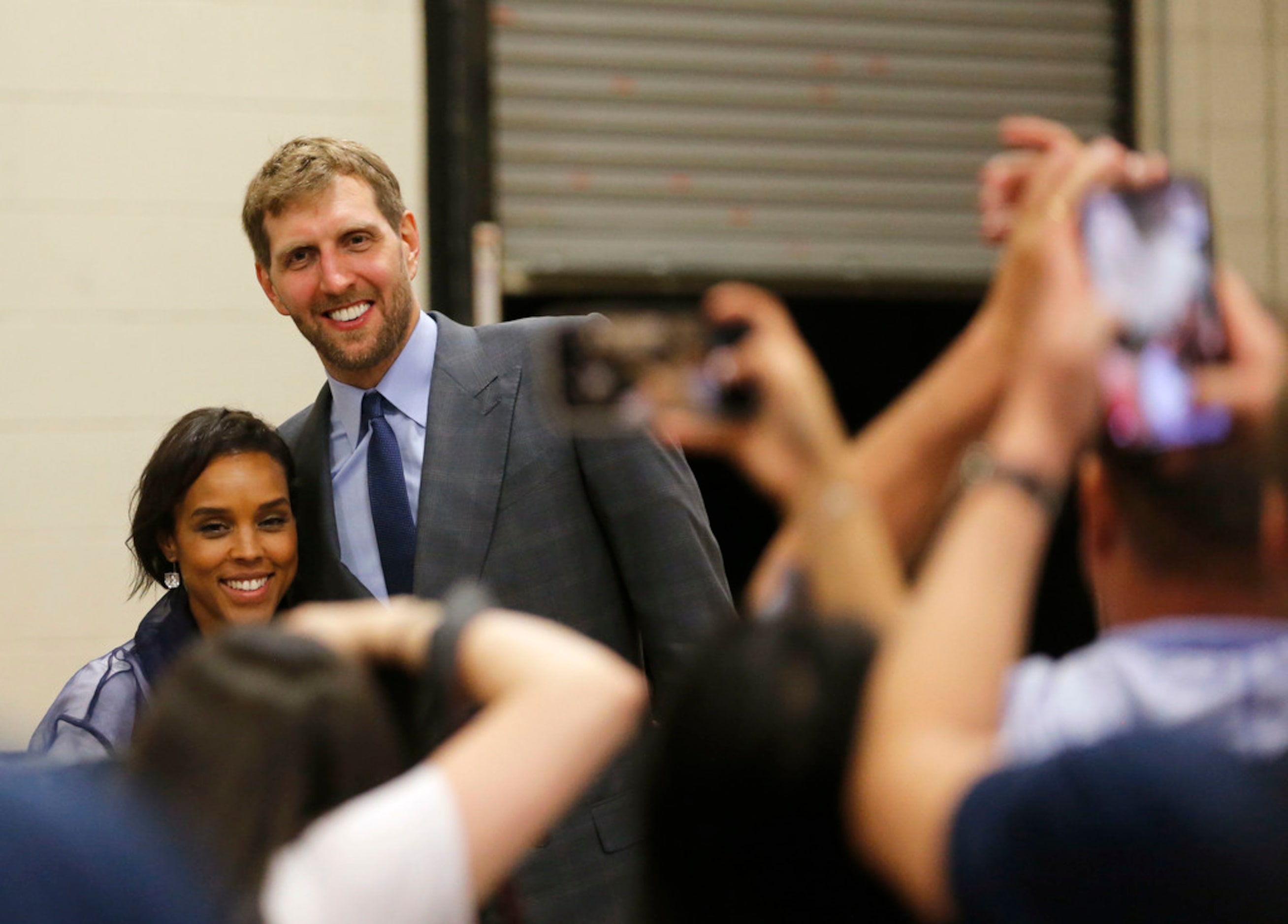 Dallas Mavericks forward Dirk Nowitzki (41) takes a photo with his wife Jessica Nowitzki...