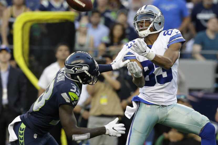 Seattle Seahawks strong safety Kelcie McCray, left, breaks up a pass intended for Dallas...
