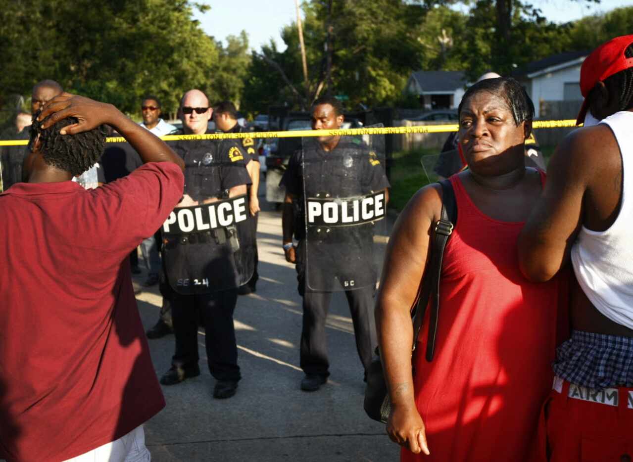 Lashaun Bradford joined others at a police line on Barber Avenue protest the shooting of...