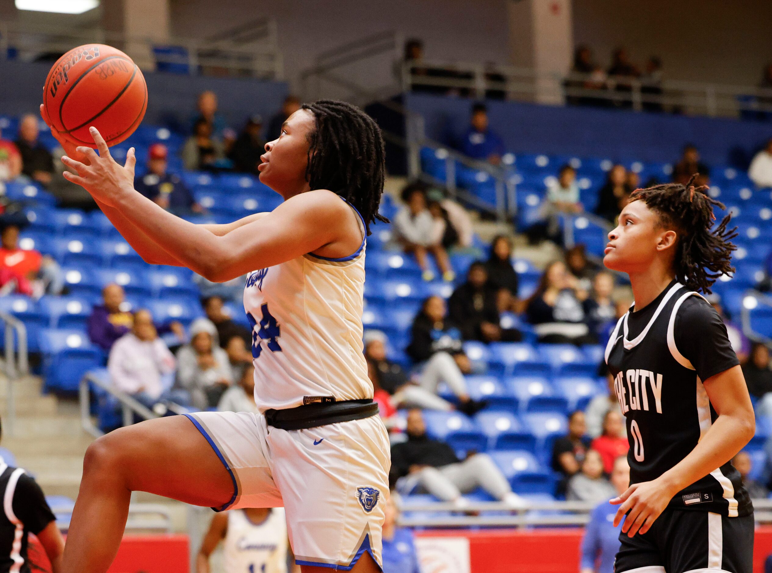 Conway high’s Alexis Cox (left) drives to the basket past Duncanville high’s Chloe Mann...