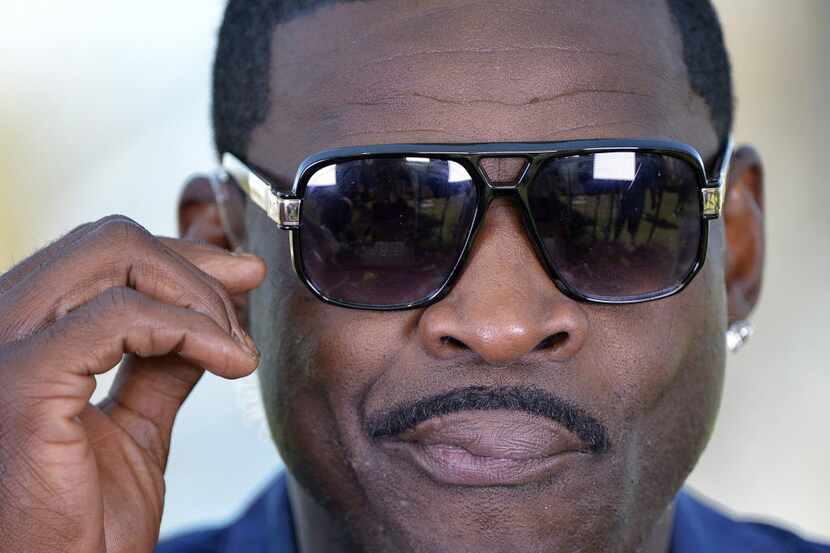Former Dallas Cowboys wide receiver Michael Irvin adjusts his glasses during a pause in his...