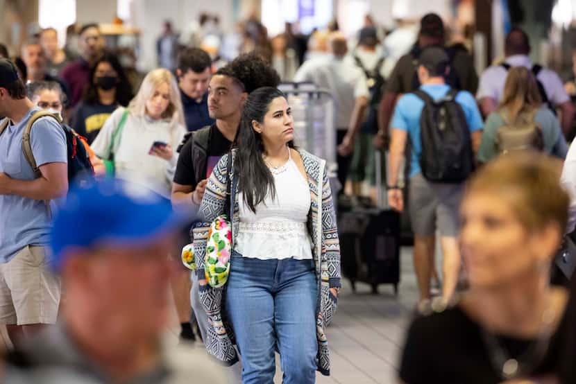 Nahir Garcia (center) from Atlanta walks through Terminal C after landing at DFW...