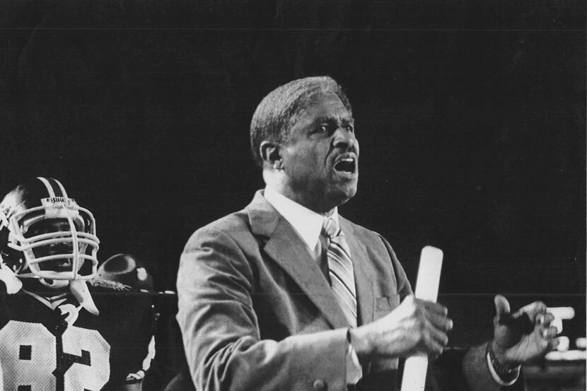 Eddie Robinson, the head coach of Grambling State University, gestures from the sidelines as...