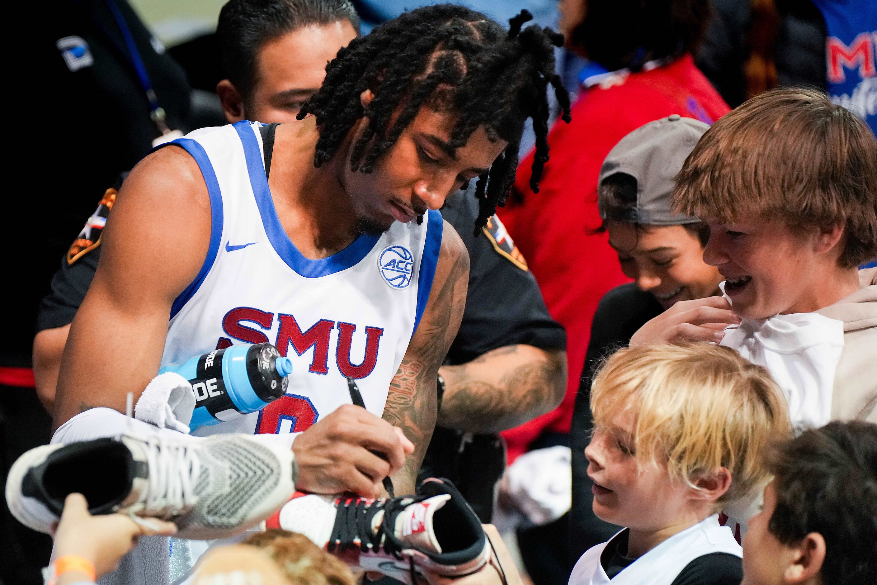 SMU guard B.J. Edwards signs autographs after a victory over Georgia Tech in an NCAA men’s...