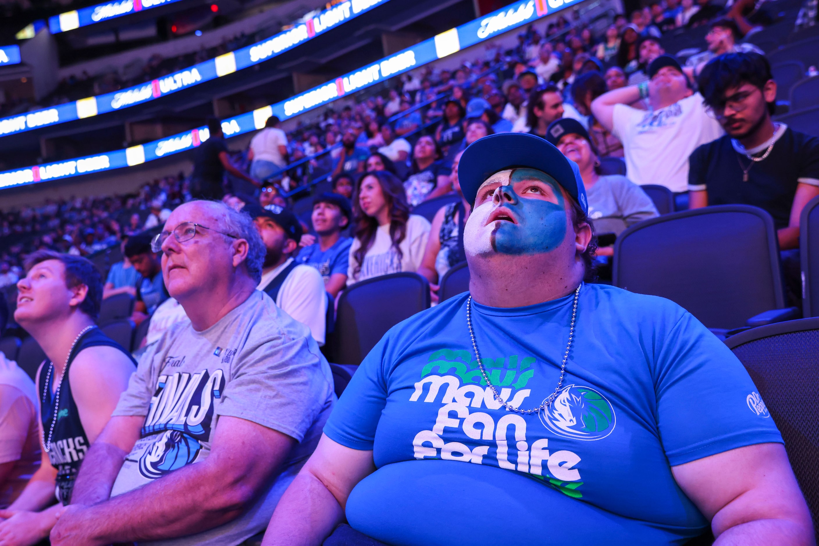 James Barrett of Irving (right), looks dejected during a watch party after Dallas Mavericks...