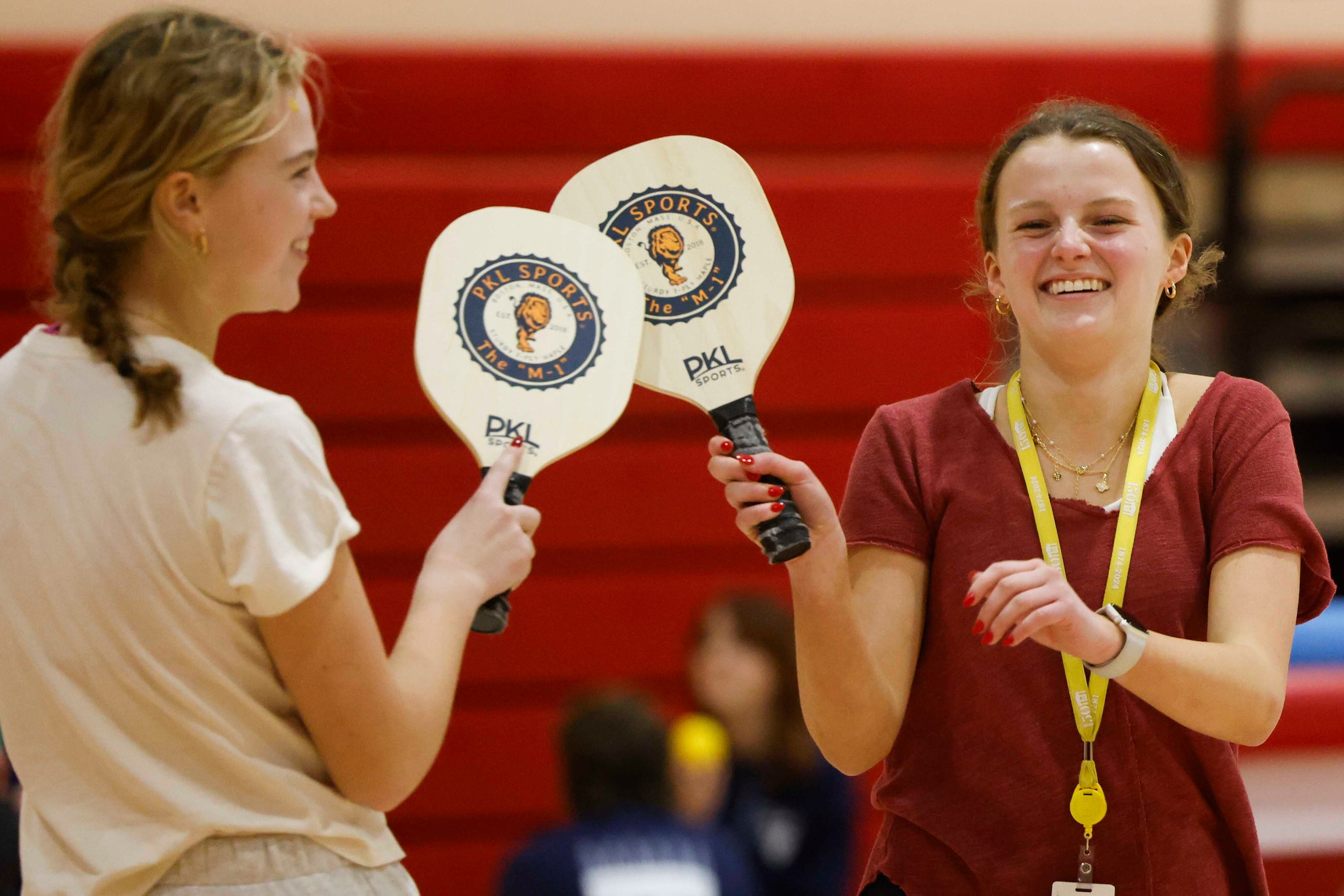 Student Emily Phillips (left) cheers with Ella Allen as they play pickle ball during the...