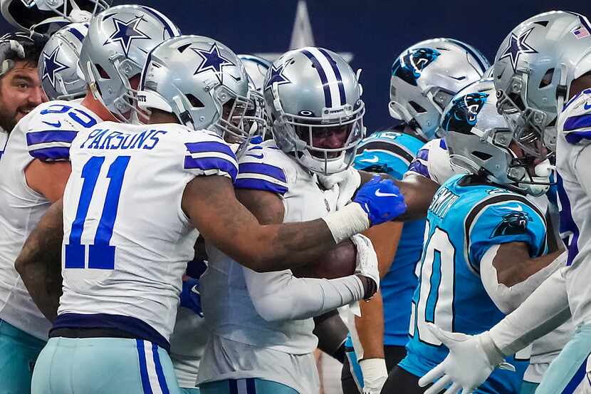Dallas Cowboys cornerback Trevon Diggs (7) is mobbed by teammates, including with linebacker...