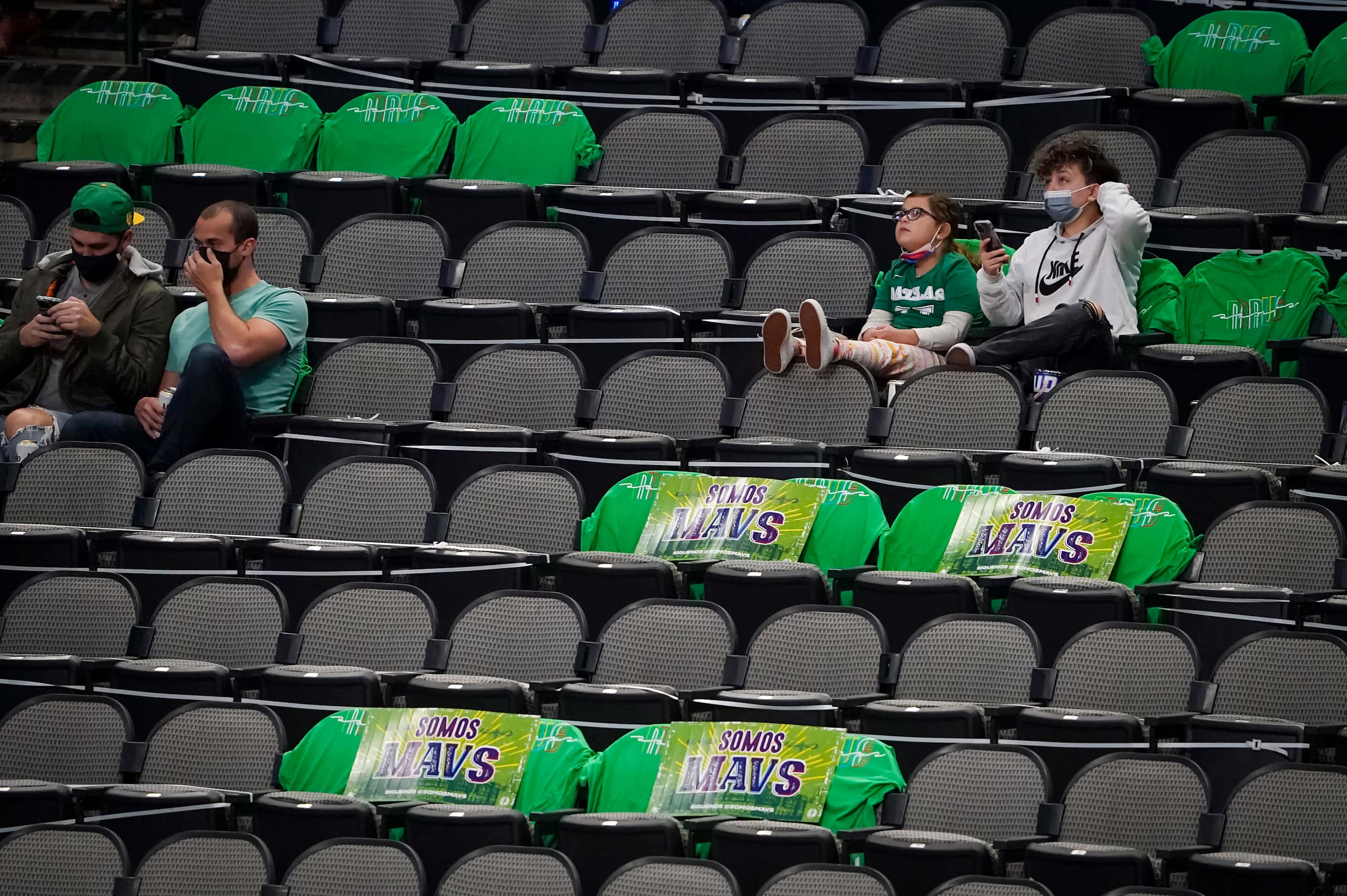 Dallas Mavericks fans sit amongst green t-shirts for St. Patrick’s Day before an NBA...