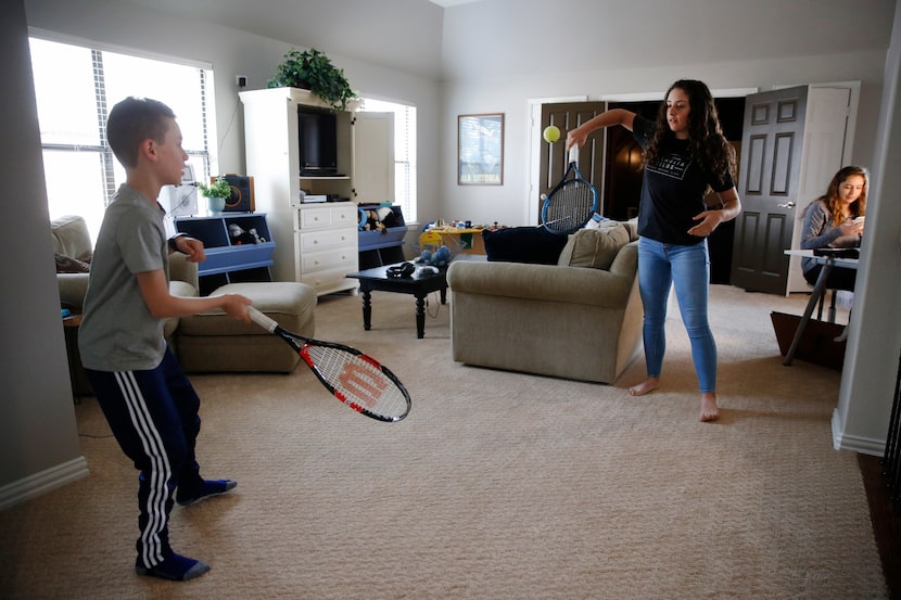 Brandon and Naomi Heit, who are both tennis players, do drills in their Frisco home while...