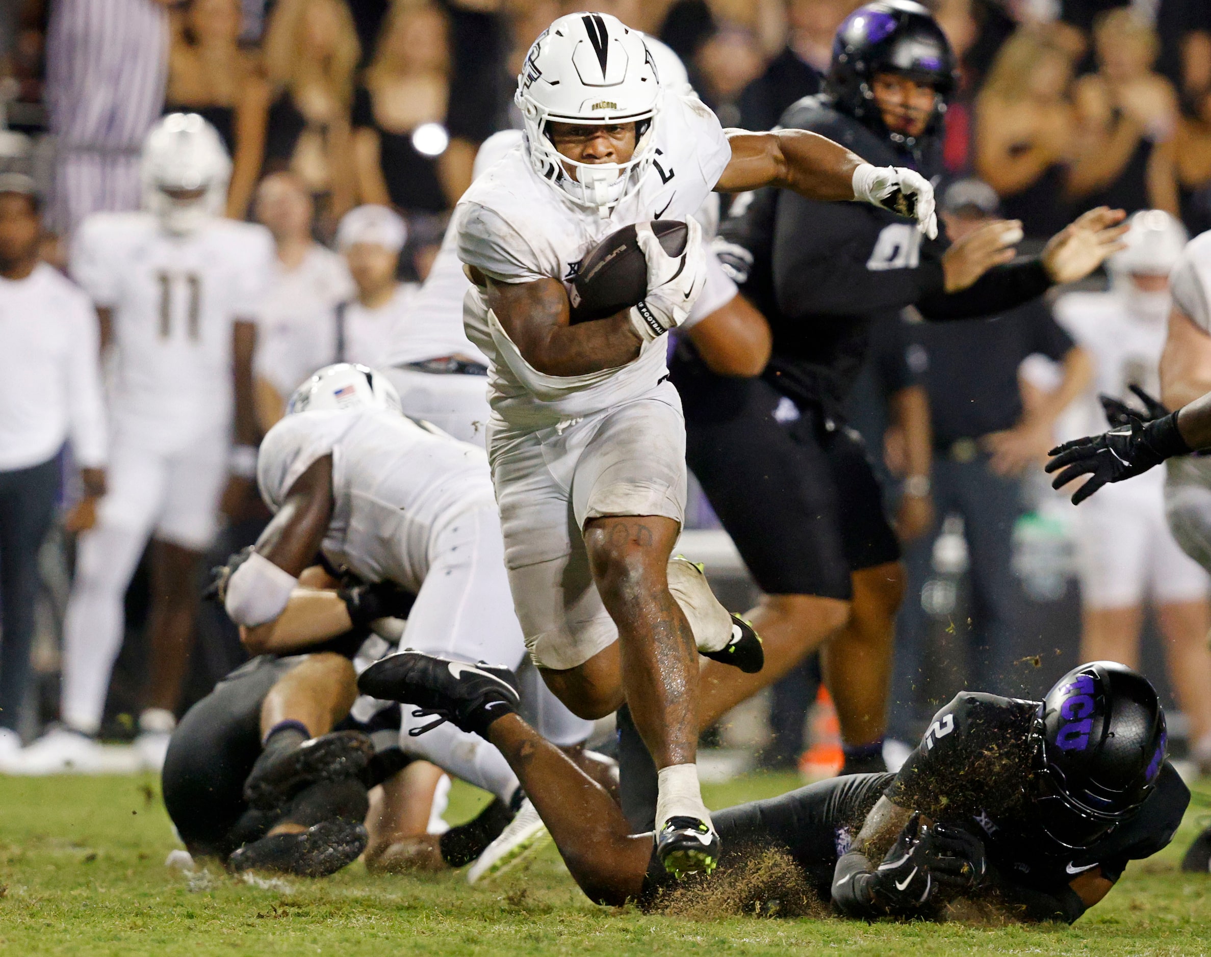 UCF running back RJ Harvey (7) runs for a touchdown as TCU safety Jamel Johnson (2) cannot...