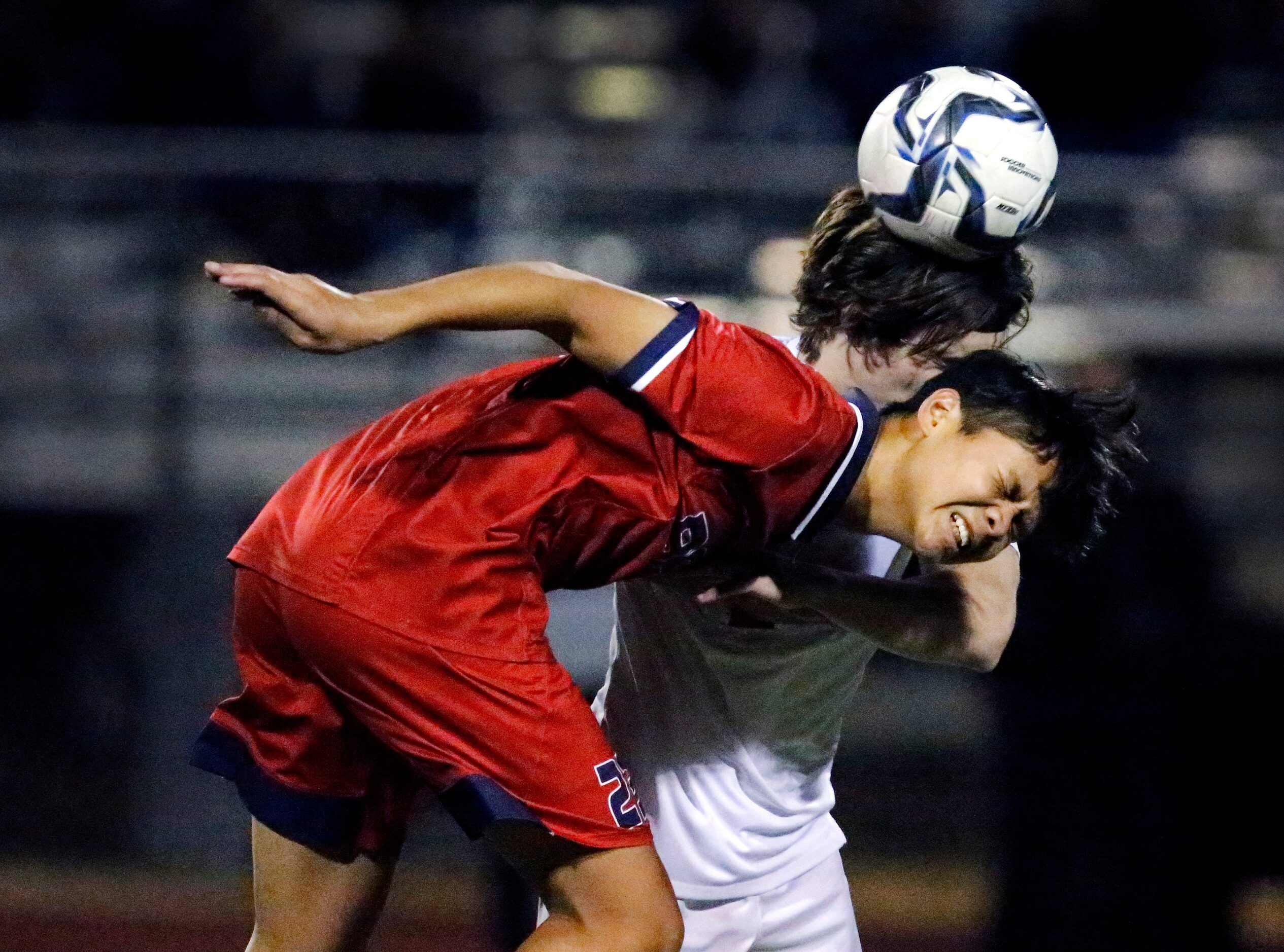 McKinney Boyd High School forward Dylan Placino (23) battles for a header with Allen High...