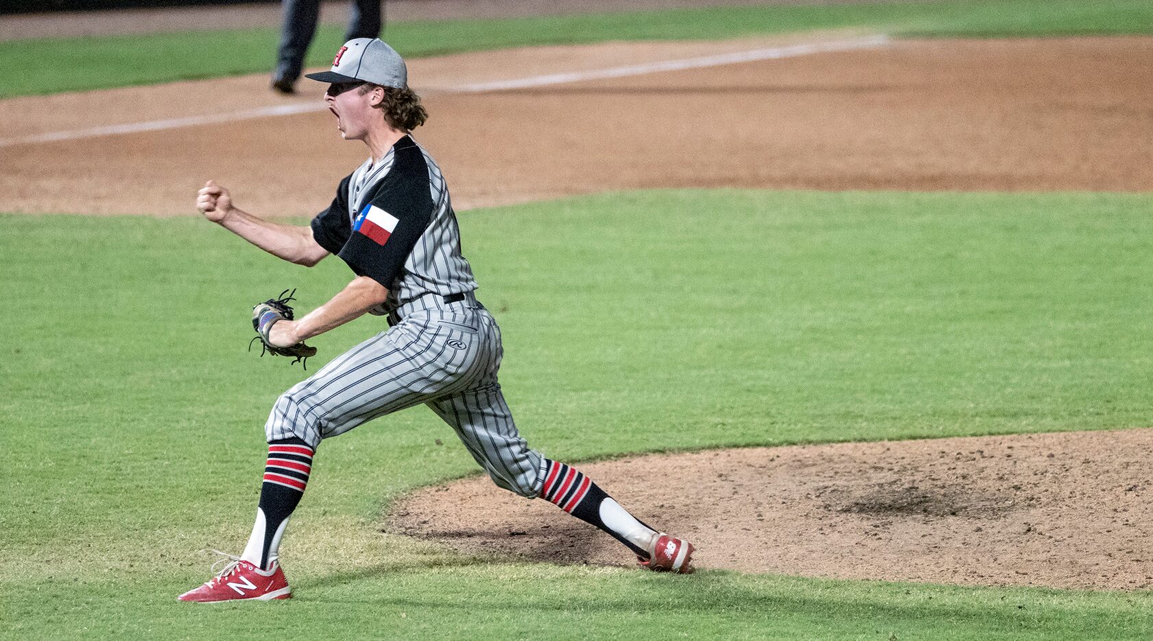 Rockwell-Heath pitcher, Baylor Baumann, (1), celebrates striking out the last Comal Smithson...