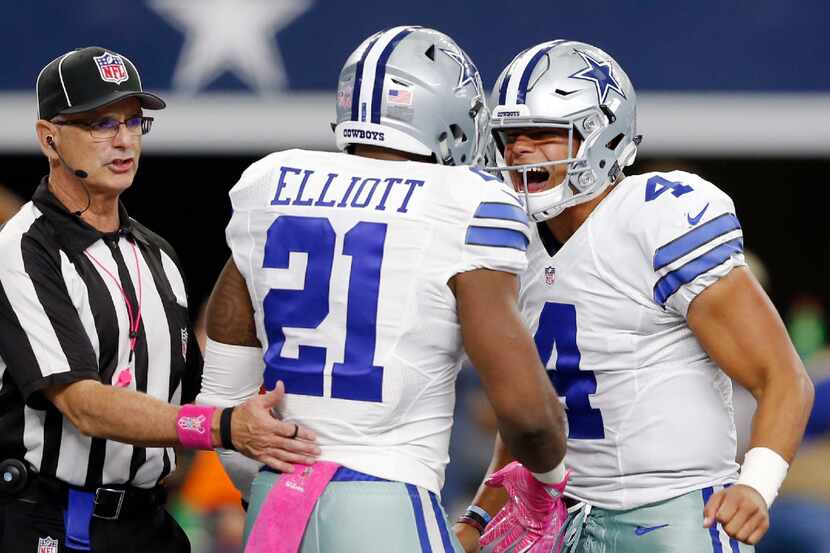 Dallas Cowboys quarterback Dak Prescott (4) congratulates Dallas Cowboys running back...