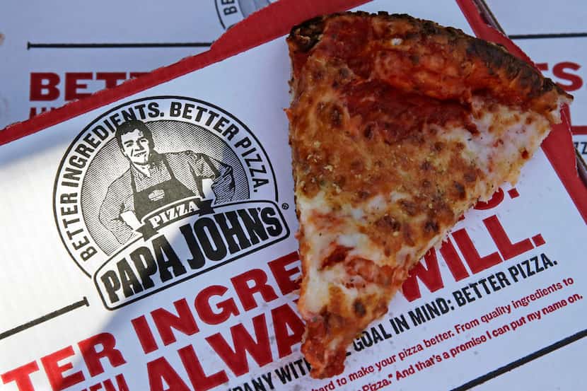 FILE- This Dec. 21, 2017, file photo shows a slice of cheese pizza at the Papa John's pizza...