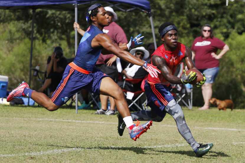 Desoto wide reciver K.D. Nixon makes a touchdown catch through the outstretched arms of...