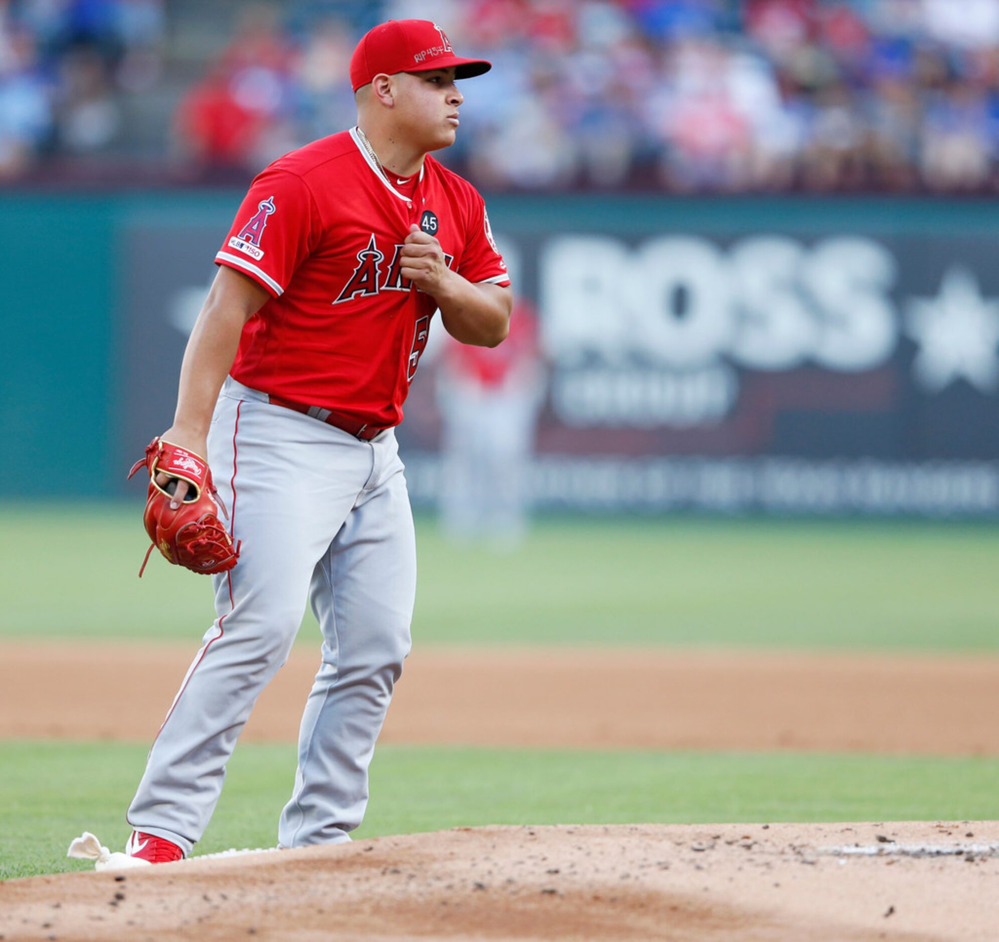 Los Angeles Angels starting pitcher Jose Suarez (54) grabs his chest after pausing at the...