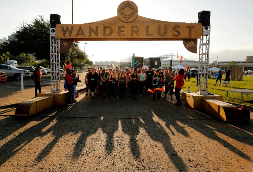 The ribbon drops as yoga enthusiasts break from the start of the Wanderlust 5K run at The...