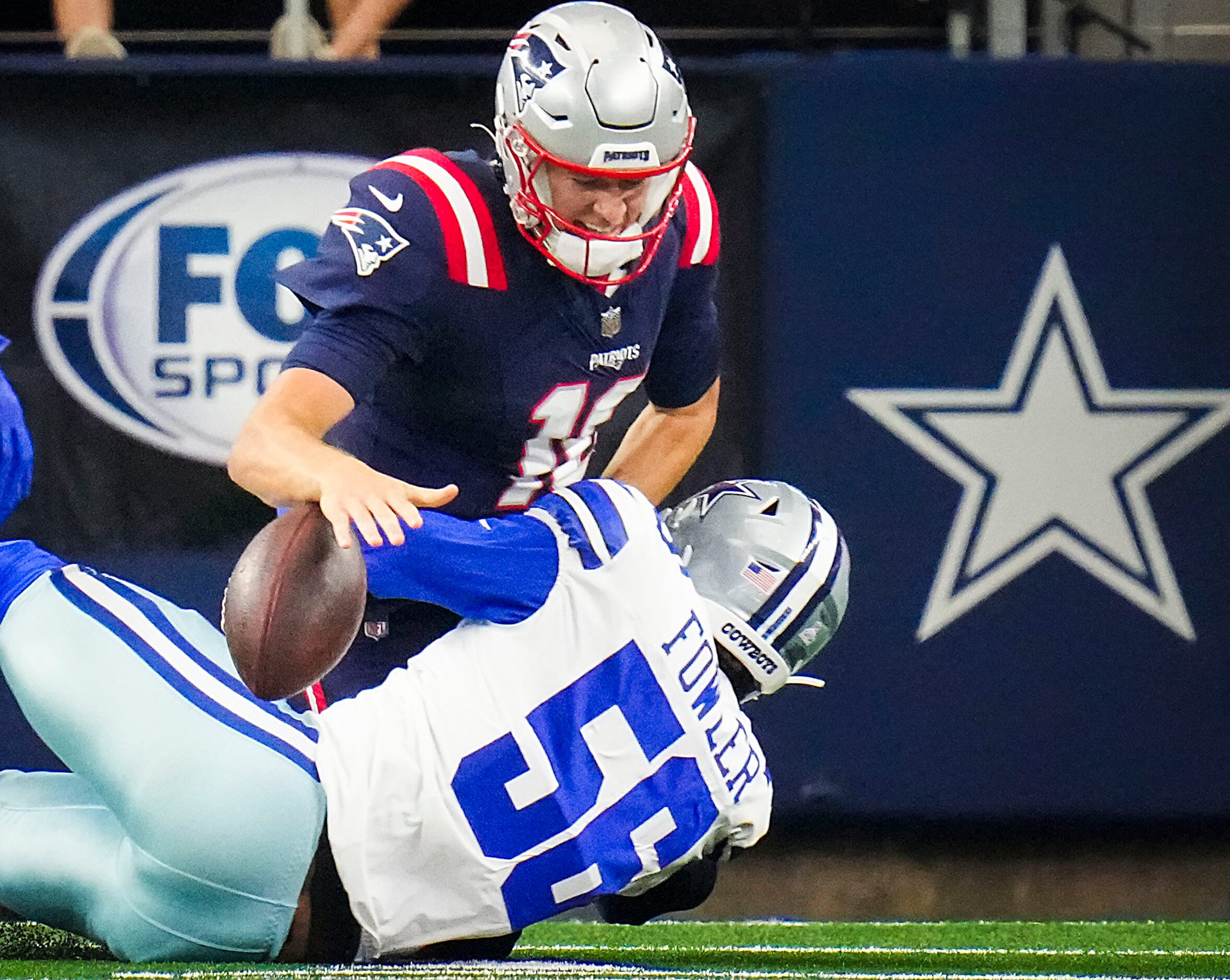 New England Patriots quarterback Mac Jones (10) fumbles as he is hit by Dallas Cowboys...