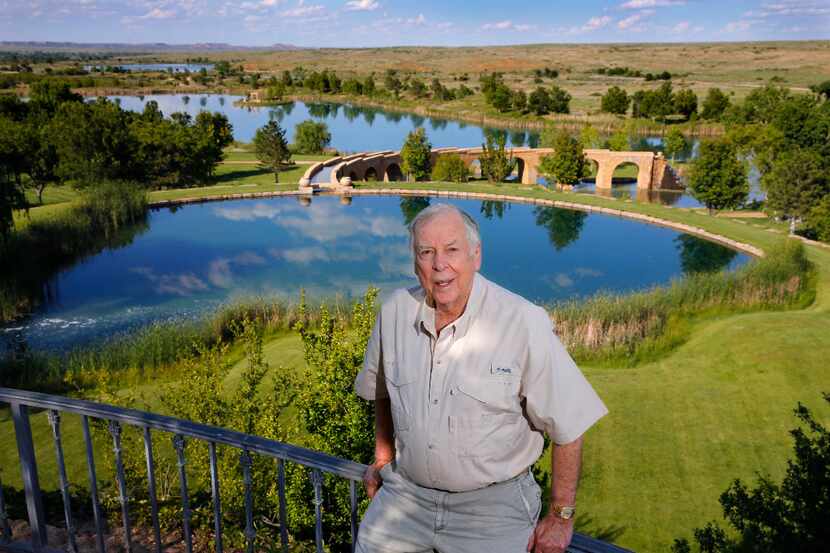 Businessman T. Boone Pickens poses for a photo before a series of man-made lakes leading...