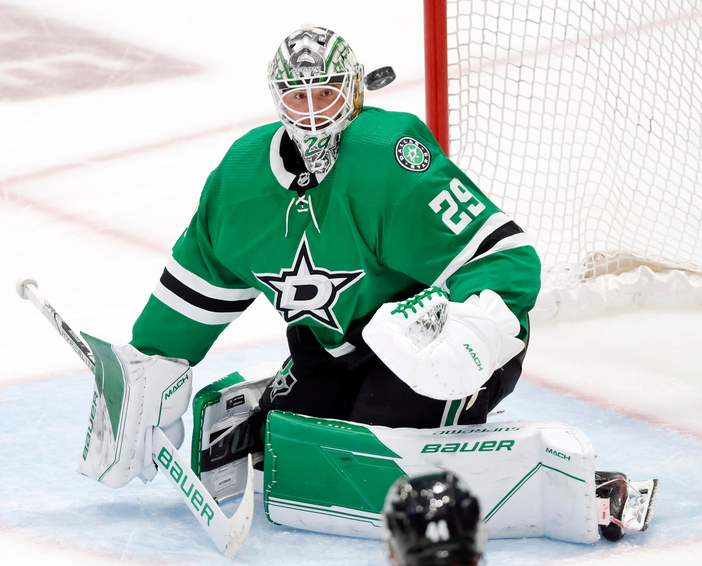 Dallas Stars goaltender Jake Oettinger (29) deflects a Seattle Kraken third period shot...