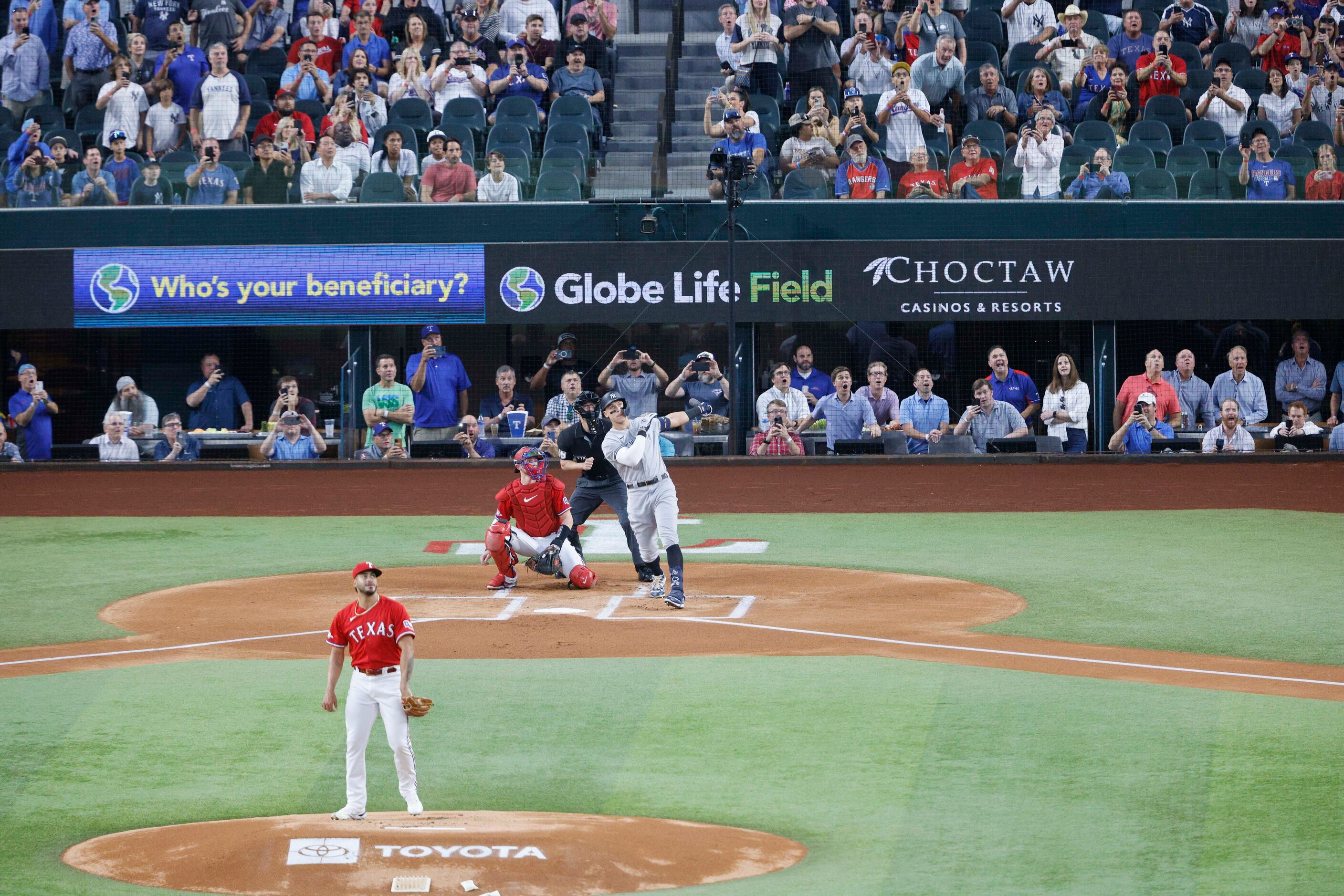 New York Yankees right fielder Aaron Judge (99) hits a home run to left field off Texas...