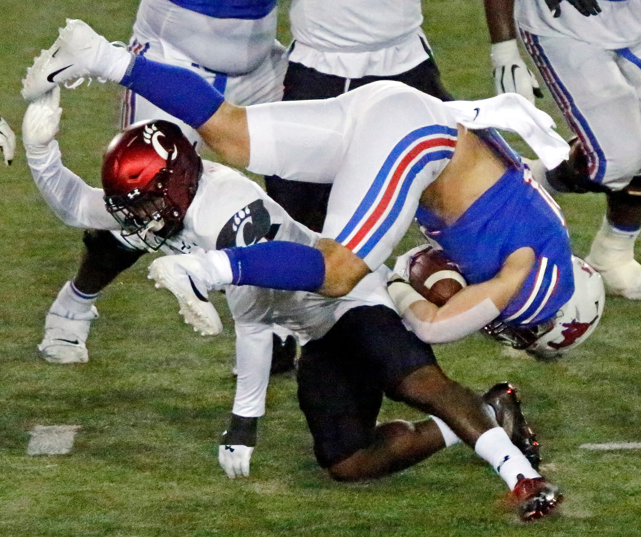 Southern Methodist Mustangs running back Tyler Lavine (31) is upended by Cincinnati Bearcats...