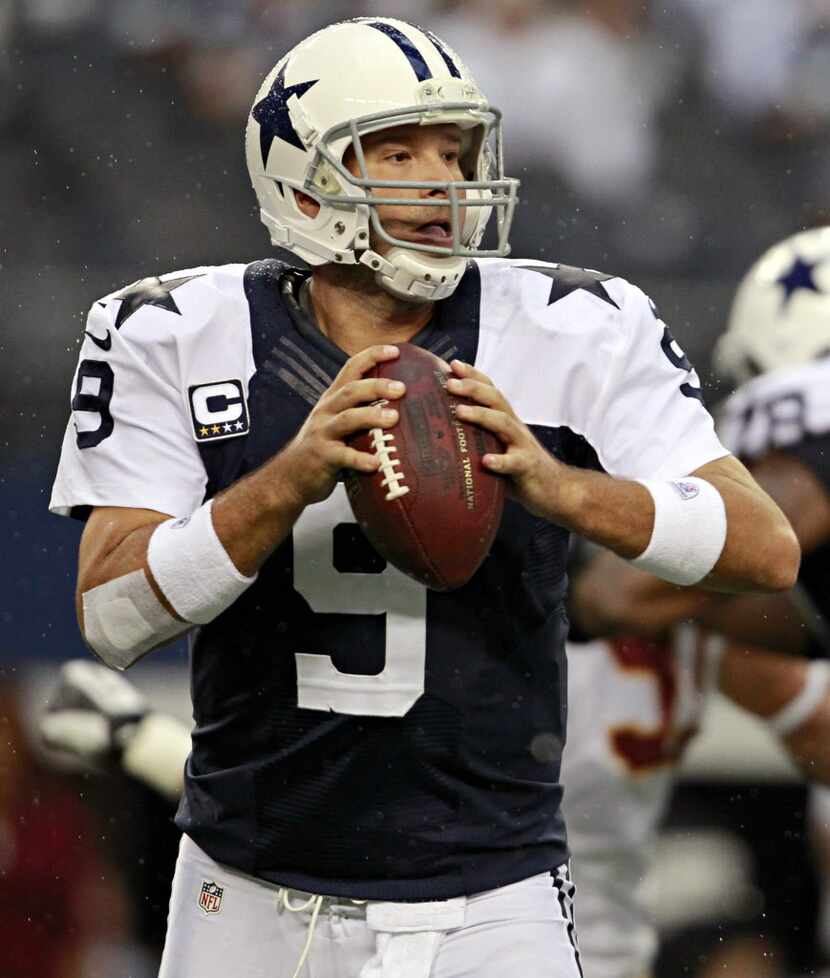 Dallas Cowboys quarterback Tony Romo looks to pass during the first half against the...
