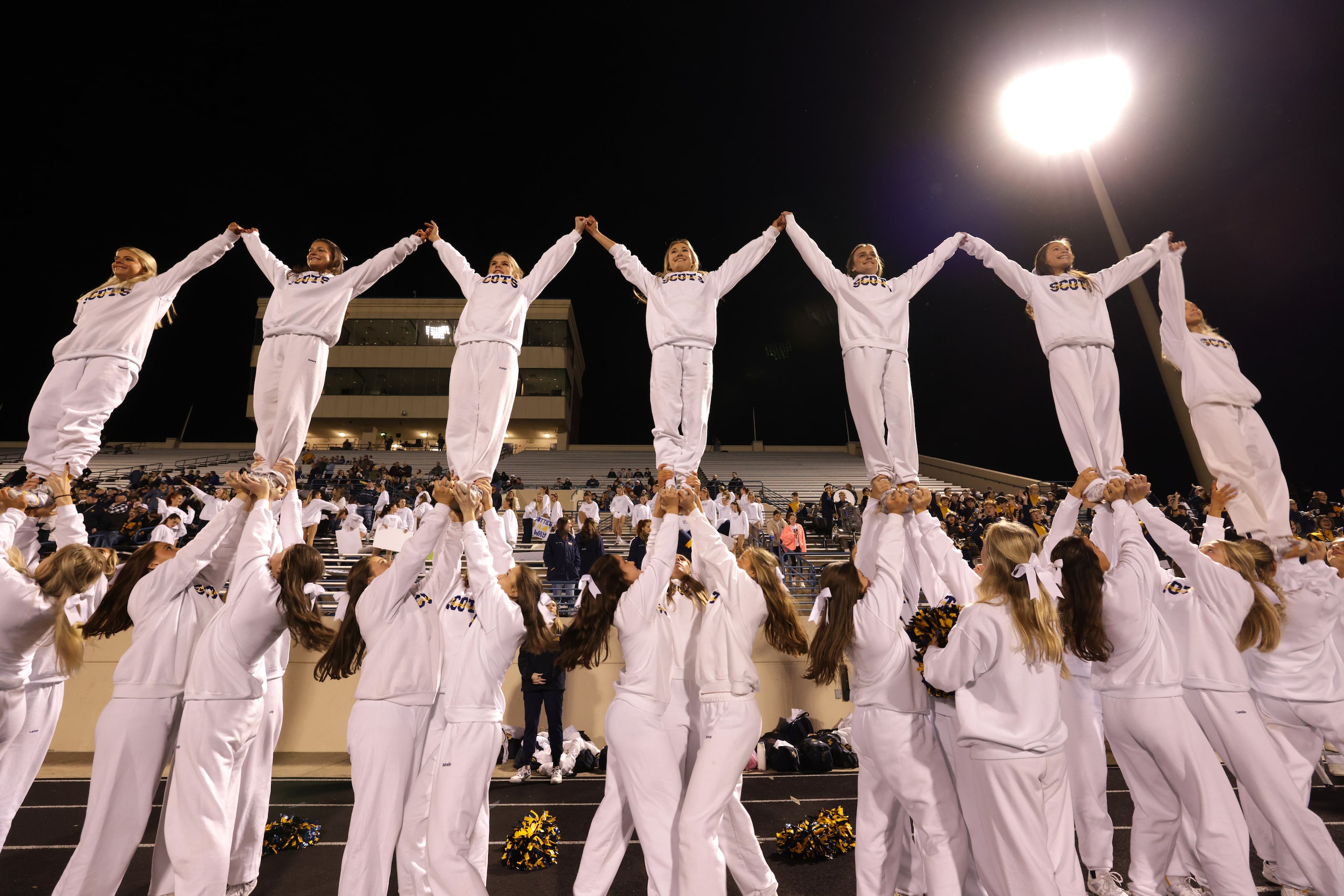 Highland Park High School cheerleaders celebrate a touchdown during a football playoff game...