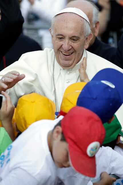 Pope Francis greets children Tuesday as he arrives at Bozzolo, near Cremona, northern Italy,...