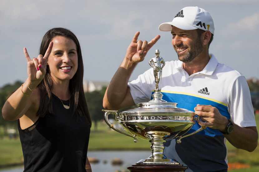 Sergio Garcia and his girlfriend Angela Akins flash UT Hook 'em Horns hand signs as they...