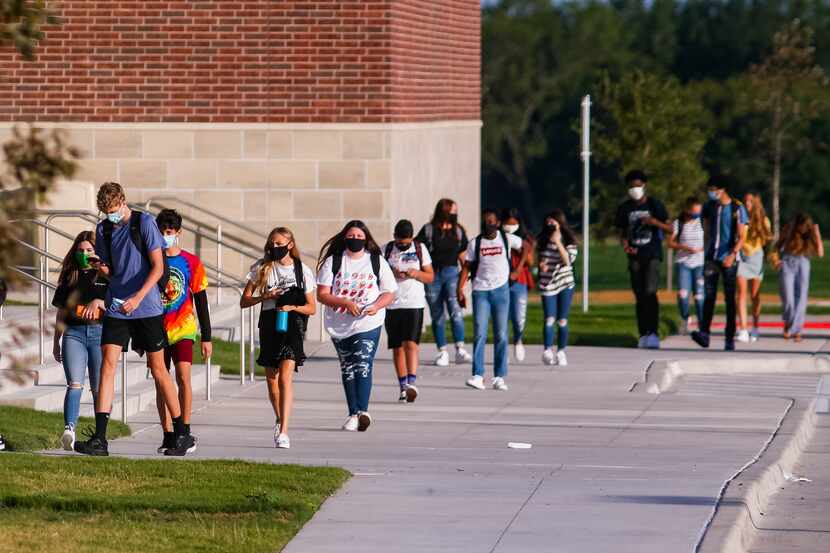 Students at Rock Hill High School walk into school for their first day back amid the...