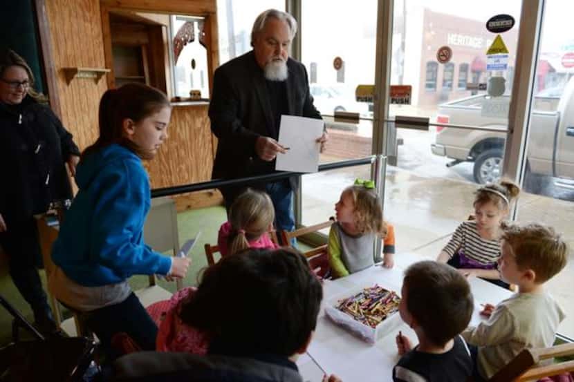 
Dal Woodruff, head pastor of The Gathering, a Mesquite-based church, talks to children...