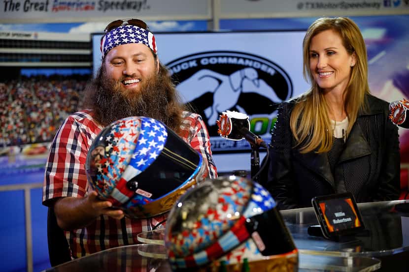 Duck Commander/A&E's "Duck Dynasty" Willie Robertson admires the race helmet adorned with...