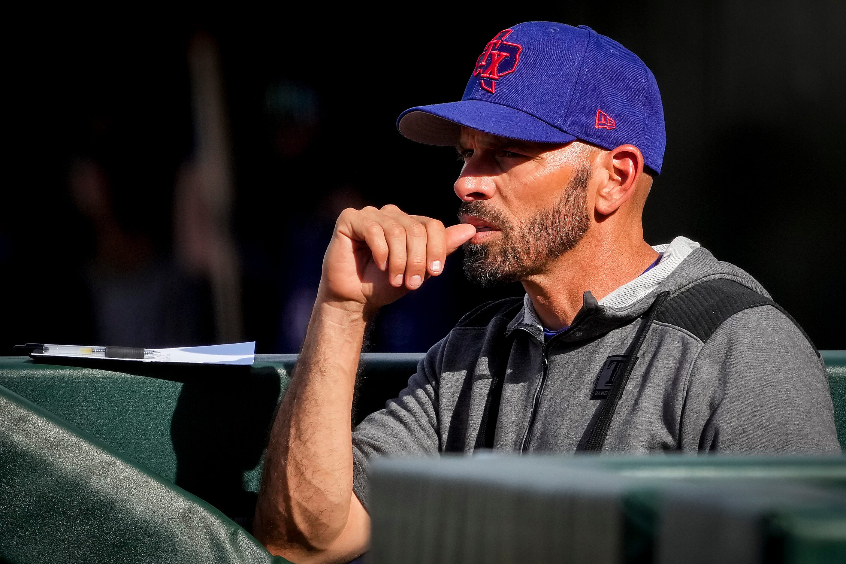 Texas Rangers manager Chris Woodward watches from the dugout during the ninth inning of a...