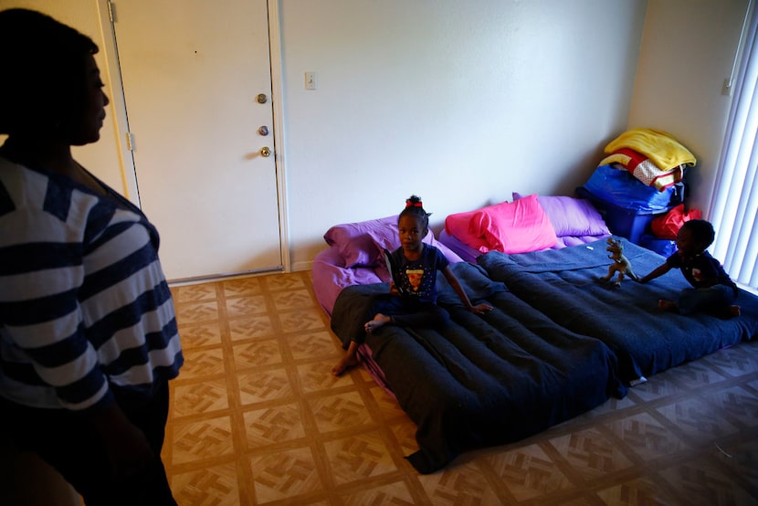 Sherrie Miles watches her two kids Nylah Miles (center), 5, and Zatakyyus Miles, 3, play in...