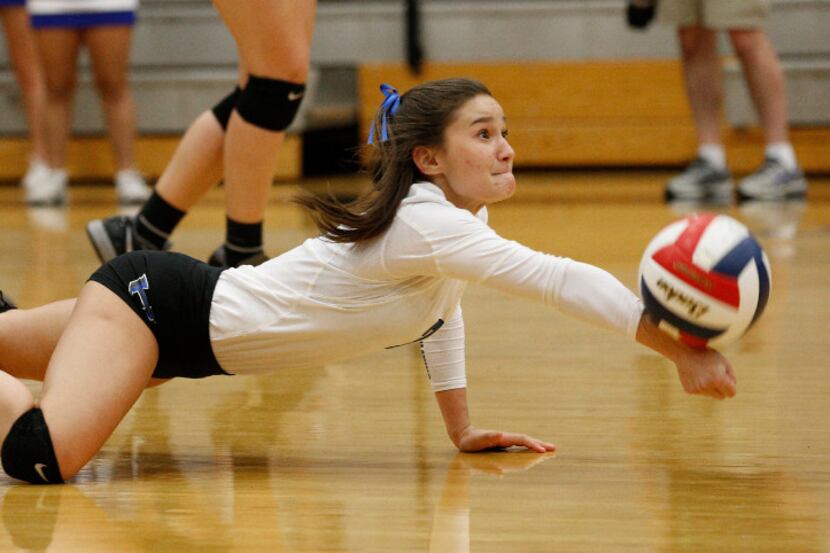 Hebron High's Annie Benbow (2) saves the ball against Trinity at Hebron High School in...