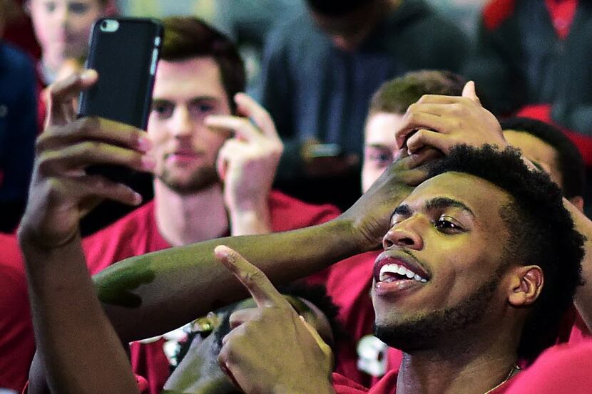 Buddy Hield takes a photo during the NCAA tournament selection show in Norman, Okla.,...