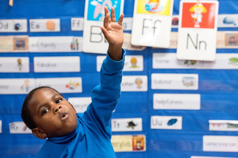 Preschooler Kameron Davis, 5, raises his hand to answer a question about nutrition during a...