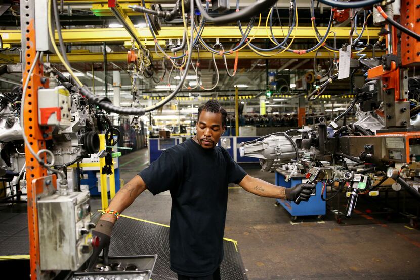 Charles Martin works on engines along the assembly line inside the General Motors plant in...
