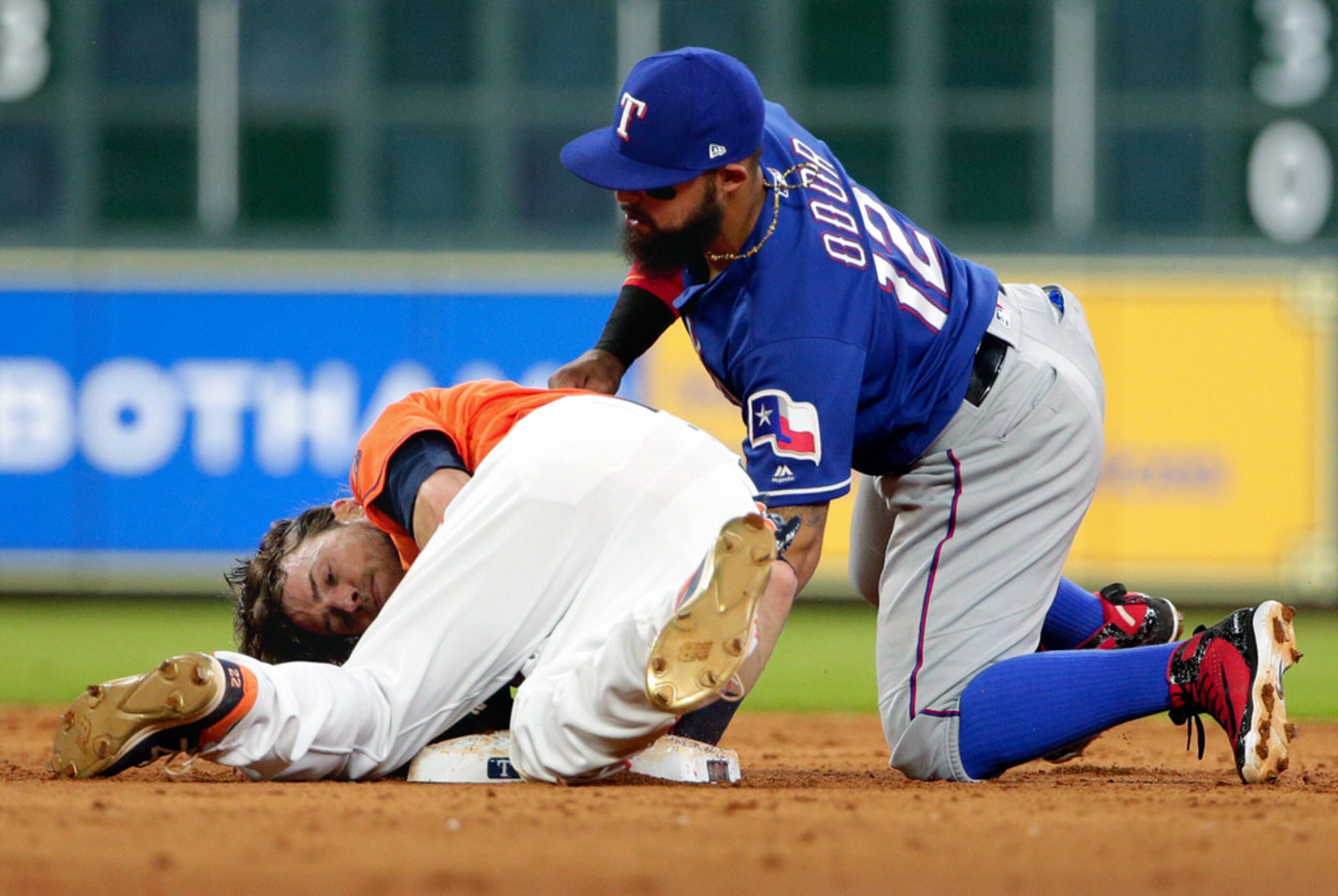 Houston Astros' Josh Reddick, left, is safe at second base as Texas Rangers second baseman...