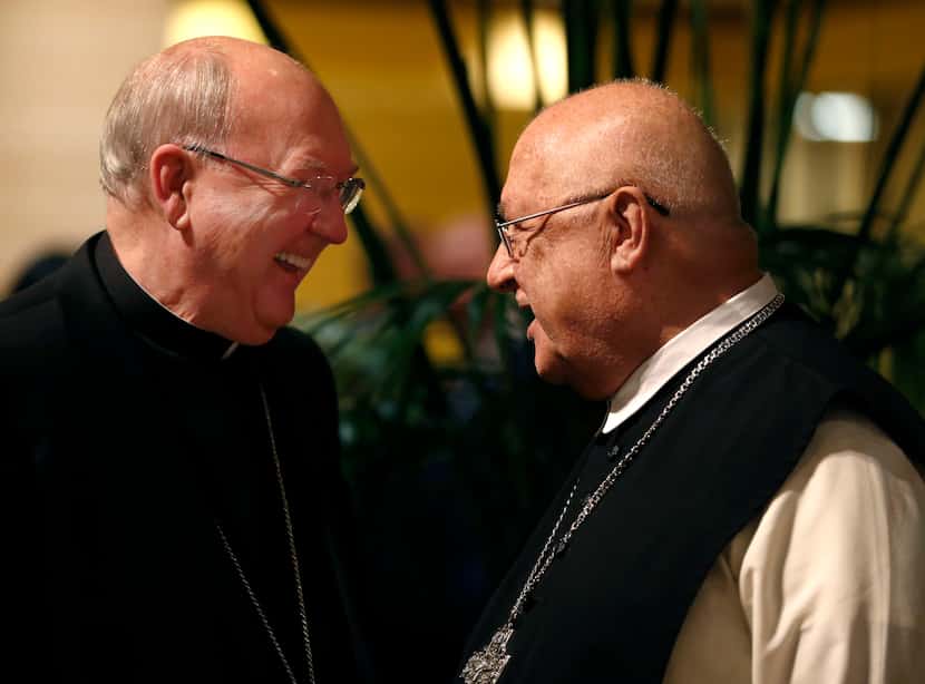 Fr. Abbot Denis Farkasfalvy (right) speaks to Bishop Kevin Farrell, of the Roman Catholic...
