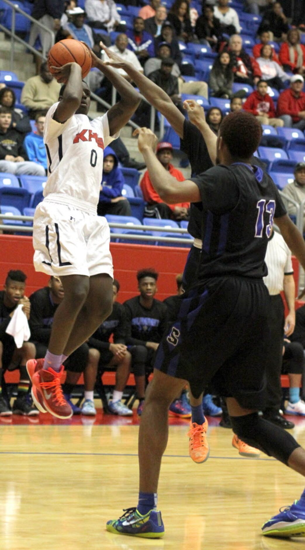 Dallas Kimball guard Jawun Evans (0) gets off a long jump shot over a couple of Mansfield...