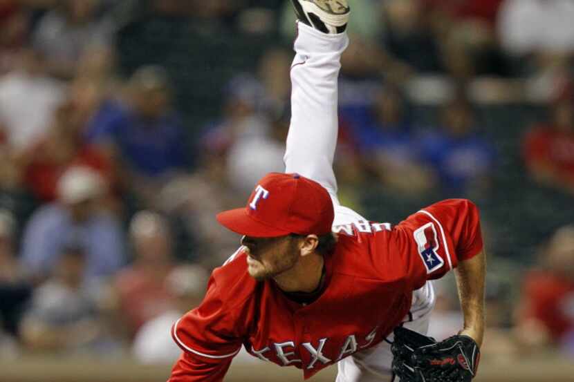 Texas rookie P Mark Hamburger throws a pitch in his first appearance with the Rangers in the...