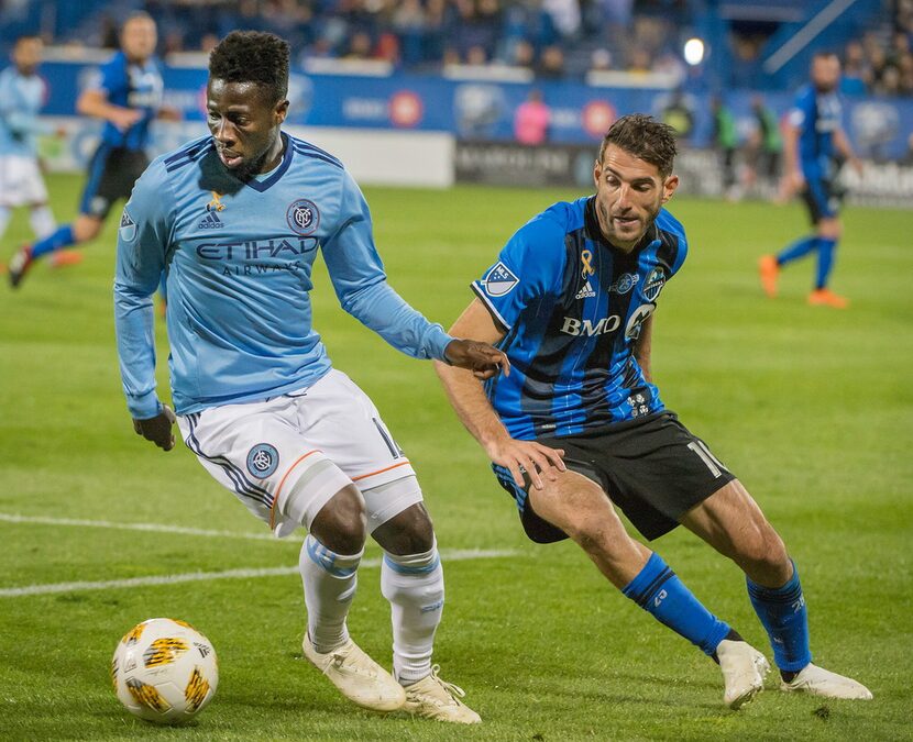 New York City FC's Ebenezer Ofori keeps the ball from Montreal Impact's Ignacio Piatti...