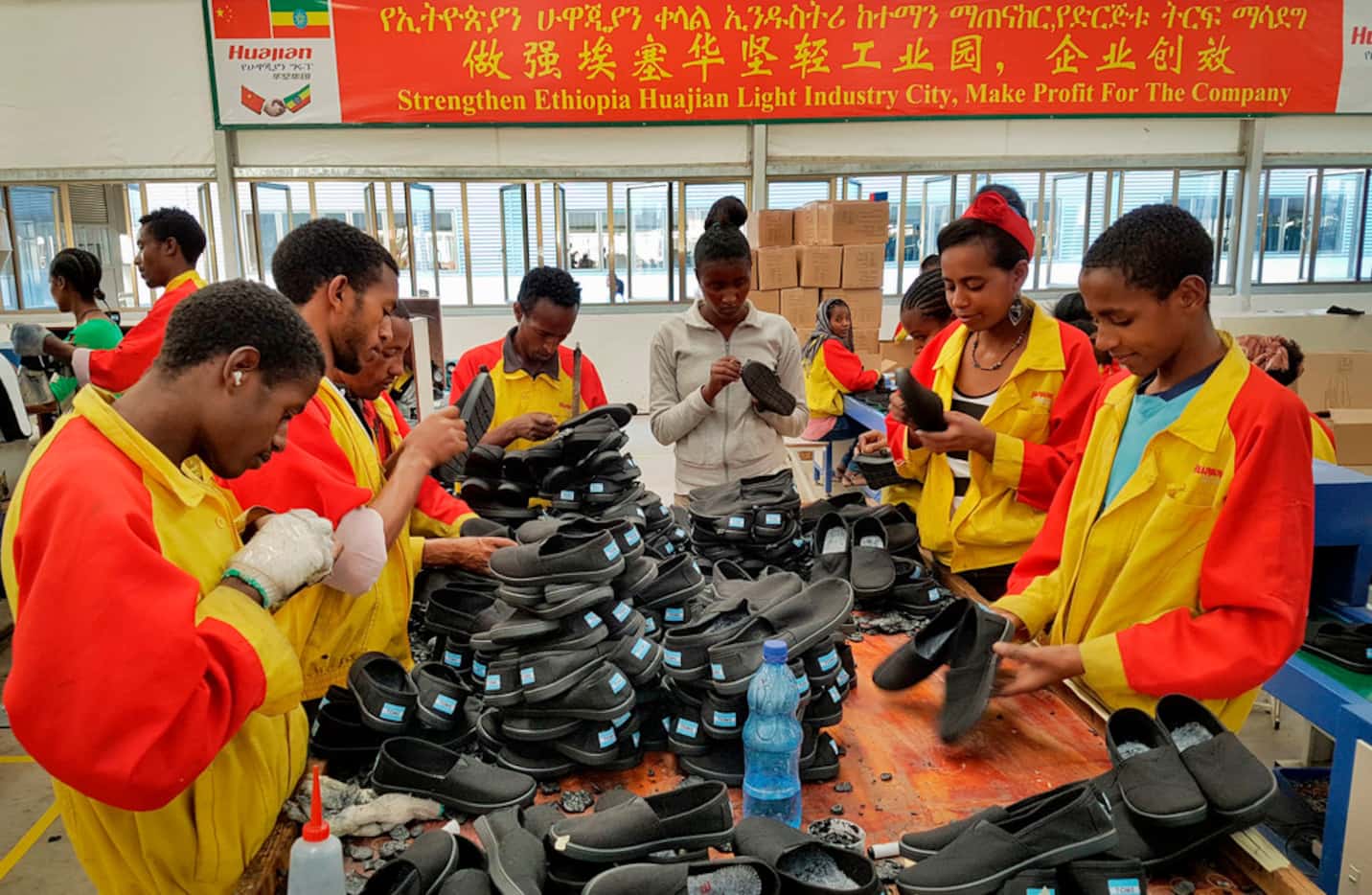 In this January photo, Ethiopian factory workers sort through shoes at the Chinese company...