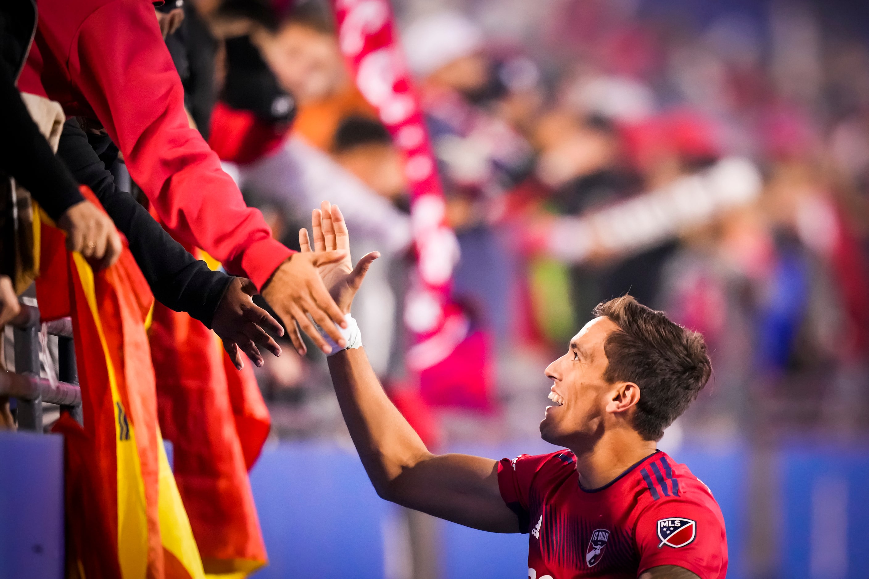 FC Dallas defender José Antonio Martínez (3) celebrates with fans after a shootout victory...